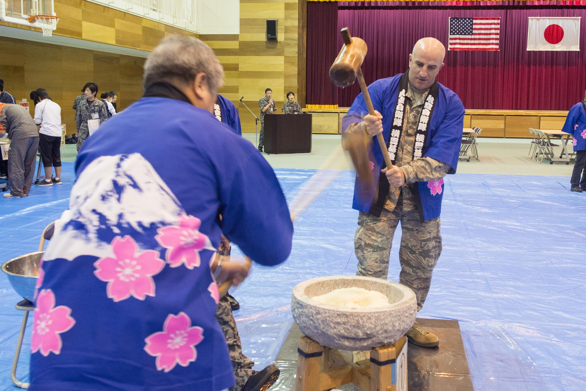 Col. Kenneth Moss, 374th Airlift Wing commander, pounds mochi during a traditional Japanese event hosted by the Japan Air Self-Defense Force at Yokota Air Base, Japan, Dec. 14, 2016. After the mochi is pounded, it is broken into smaller pieces and formed into different shapes. (U.S. Air Force photo by Senior Airman David C. Danford/Released)