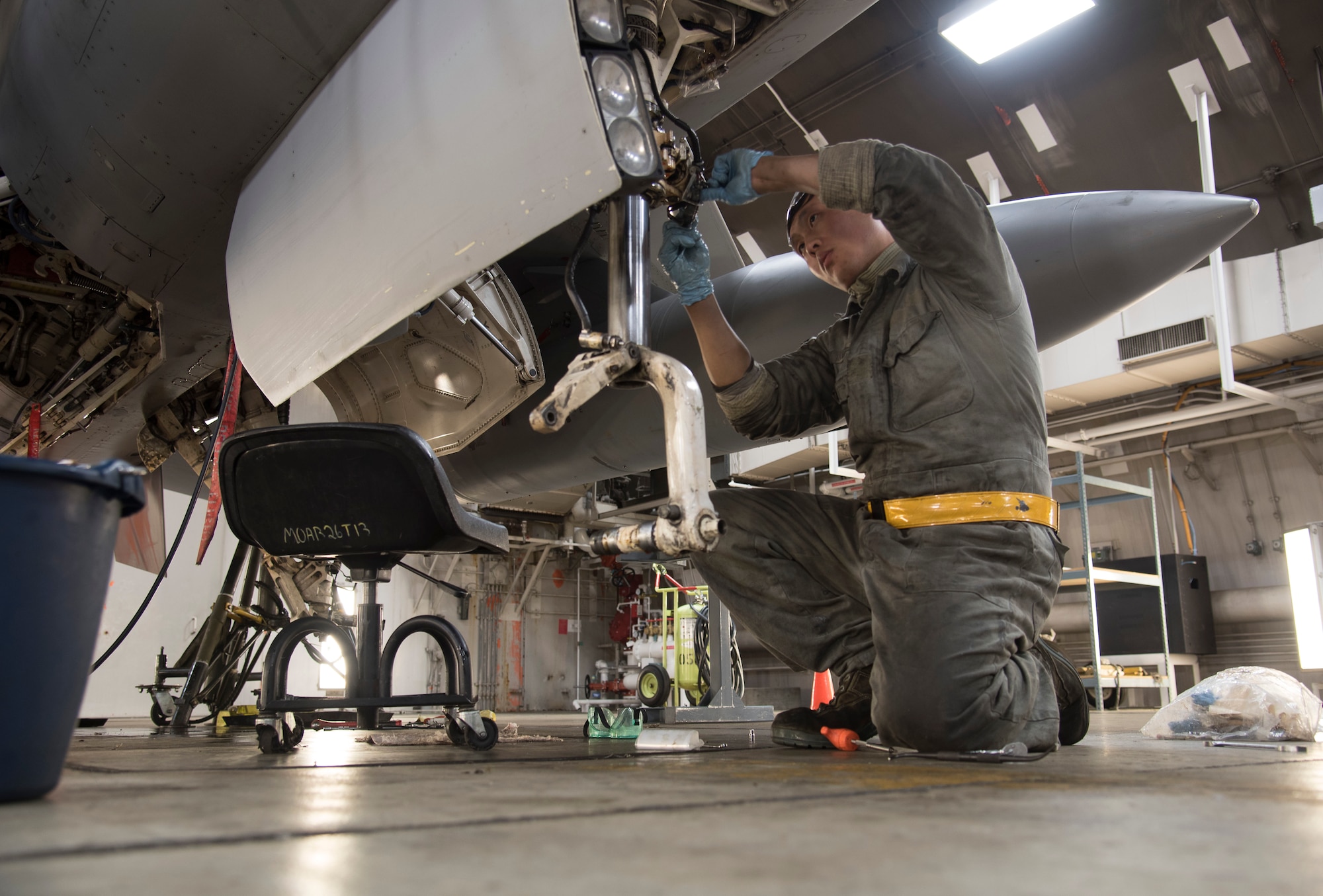 U.S. Air Force Senior Airman Harrison Lei, a 14th Aircraft Maintenance Unit crew chief, loosens a nose steering potentiometer at Misawa Air Base, Japan, Dec. 12, 2016. The potentiometer uses wires to control the steering of the aircraft. Loosening the nose steering allows maintainers to inspect the wires powering the aircraft landing gear ensuring wires are firmly connected. (U.S. Air Force photo by Airman 1st Class Sadie Colbert)