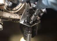 U.S. Air Force Senior Airman Harrison Lei, a 14th Aircraft Maintenance Unit crew chief, tightens a nose steering potentiometer at Misawa Air Base, Japan, Dec. 12, 2016. Each aircraft is assigned two crew chiefs who oversee the maintenance and flight checks for every mission. (U.S. Air Force photo by Airman 1st Class Sadie Colbert)