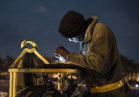 U.S. Air Force Senior Airman Joseph Chapman, a 14th Aircraft Maintenance Unit crew chief, looks over aircraft forms at Misawa Air Base, Japan, Dec. 12, 2016. Aircraft forms show all the servicing the aircraft needs as well as any fixes the prior crew performed. Paperwork is important because it identifies the status of the aircraft and determines whether it will fly or not. (U.S. Air Force photo by Airman 1st Class Sadie Colbert)