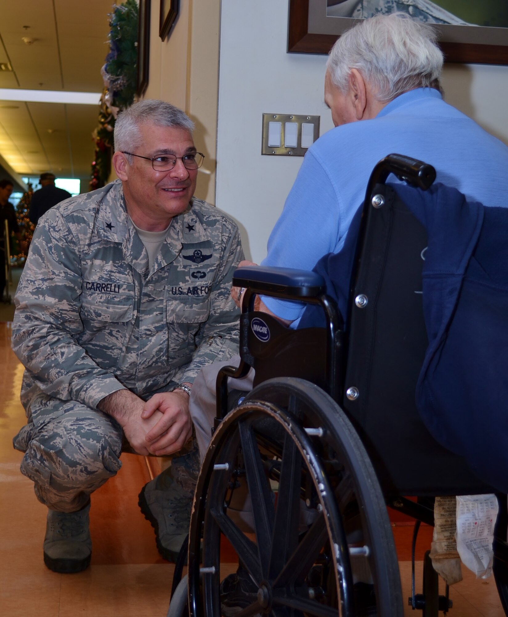 The Adjutant General (TAG) of the Pa. National Guard Brig. Gen. Tony Carrell speaks with a resident at the Delaware Valley Veterans Home, Philadelphia, Dec. 13, 2016. The day before, a visit to the Gino J. Merli Veterans’ Center in Scranton, Pa., kicked off the proposed 10-day convoy to six veteran rehabilitation and care facilities across the state for Carrelli, the state’s senior military leadership and Pa. Guardsmen. (U.S. Air National Guard photo by Tech. Sgt. Andria Allmond)