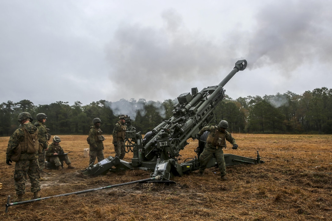 Marines fire a 155 mm howitzer during a helicopter support team exercise at Marine Corps Base Camp Lejeune, N.C., Dec, 13, 2016. Marines assigned to Landing Support Platoon, Combat Logistics Battalion 6 and the 10th Marine Regiment, 2nd Marine Division participated in the training. Marine Corps photo by Lance Cpl. Jon Sosner