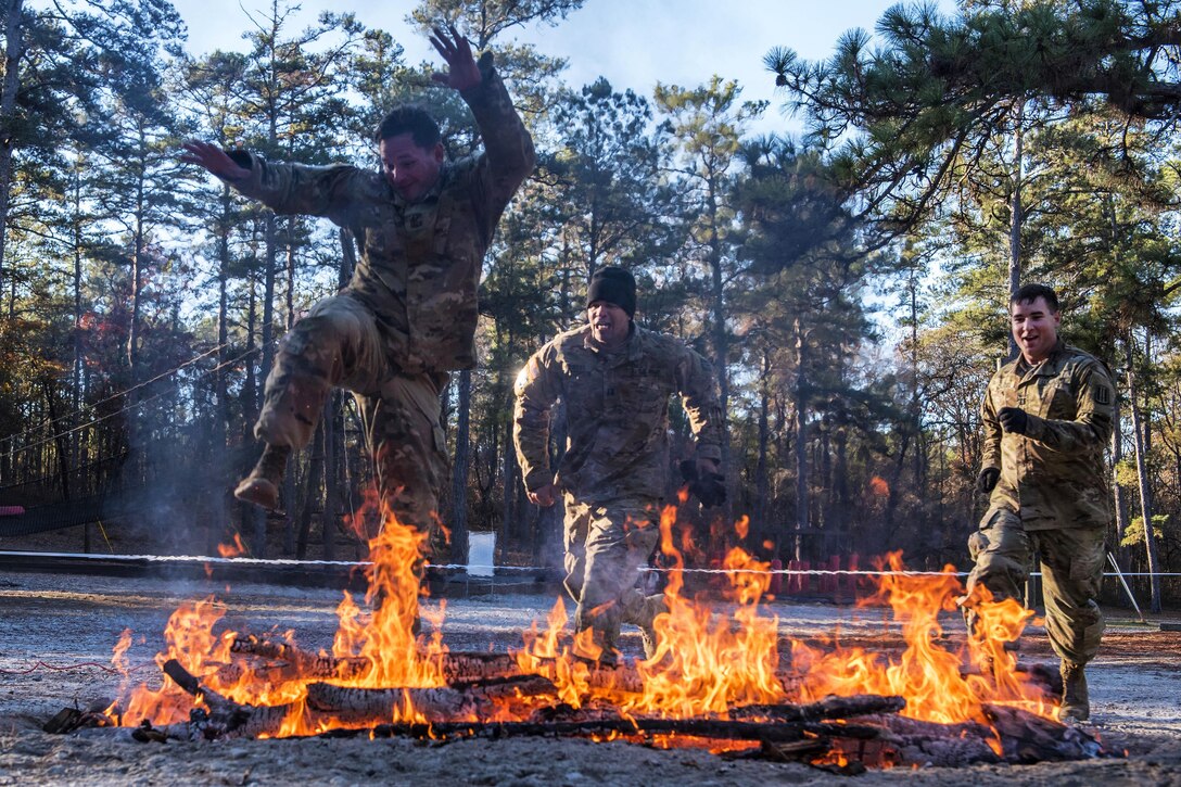 Soldiers jump over the fire pit obstacle while participating in the Rubicon Command Team Challenge at Fort Jackson, S.C., Dec. 9, 2016. Army photo by Sgt. 1st Class Brian Hamilton