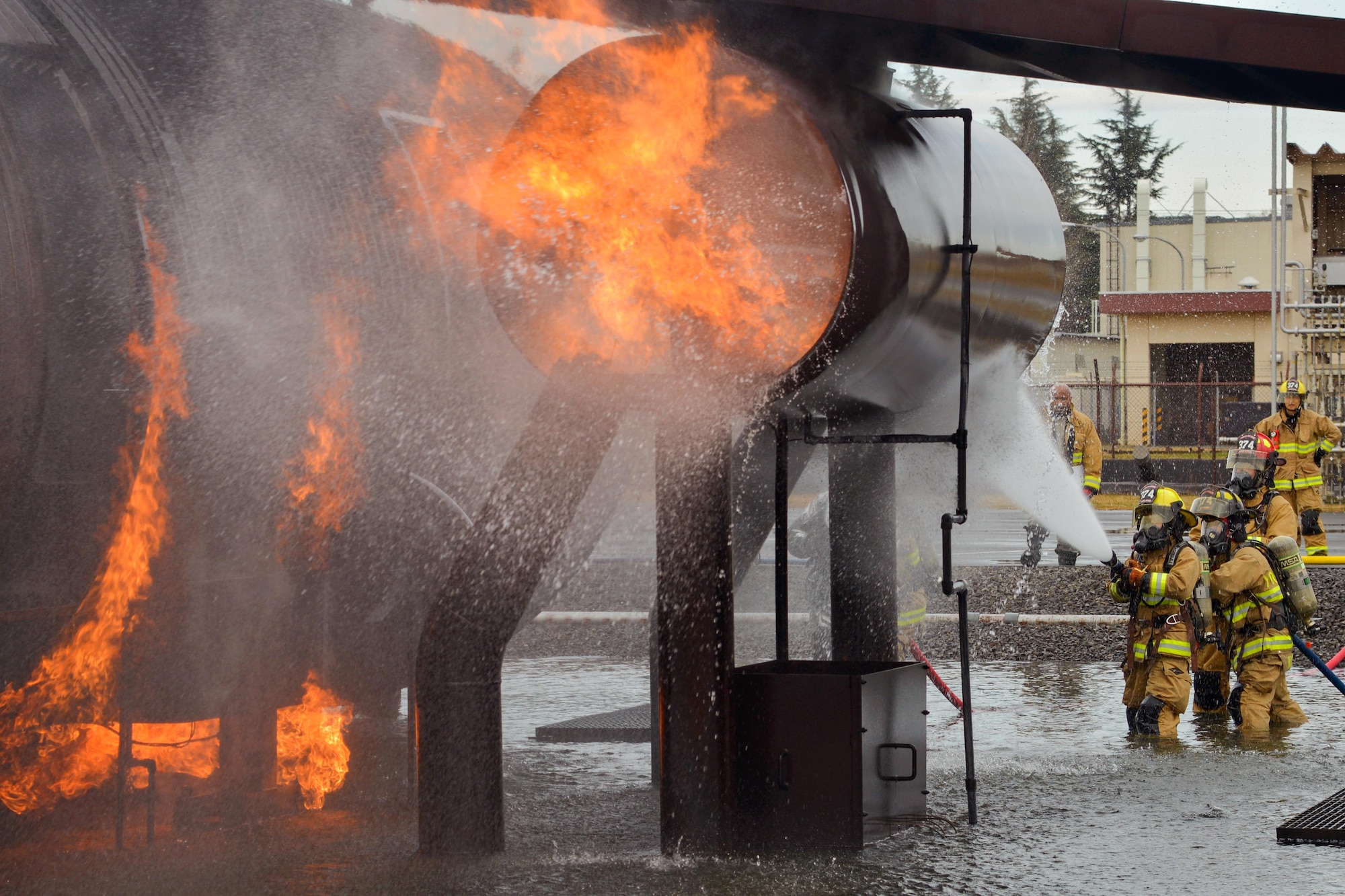 Firefighters with the 374th Civil Engineer Squadron put out a simulated aircraft fire during a training scenario at Yokota Air Base, Japan, Dec. 14, 2016. The training consisted of a training aircraft burning with two engine fires with leaking fuel spreading on the ground to simulate an aircraft on the runway needing assistance. (U.S. Air Force photo by Staff Sgt. David Owsianka)