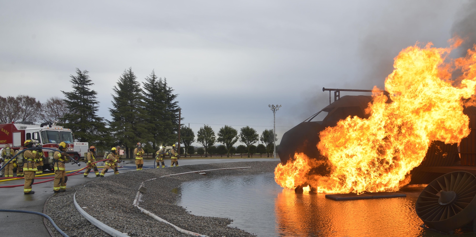 Firefighters with the 374th Civil Engineer Squadron prepare for a training scenario at Yokota Air Base, Japan, Dec. 14, 2016. During the training the firefighters were split into three teams of two, with two teams extinguishing the fires and the remaining team on standby providing a safety line to help the primary teams. (U.S. Air Force photo by Staff Sgt. David Owsianka)