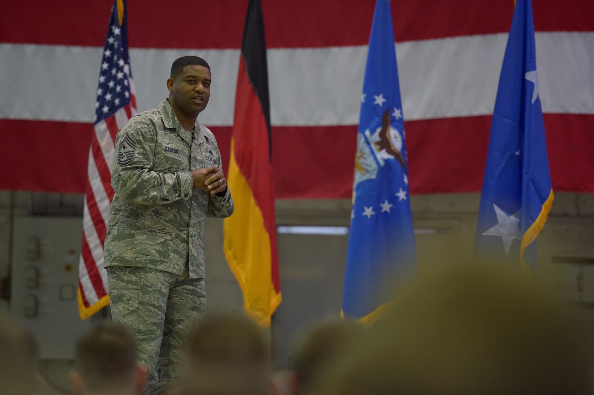 Chief Master Sgt. Phillip Easton, 3rd Air Force and 17th Expeditionary Air Force command chief, talks about the importance of family during an all call at Hangar One on Spangdahlem Air Base, Germany, Dec. 14, 2016. During the 3rd AF leadership visit they were given a tour around base and met with Airmen. (U.S. Air Force photo by Staff Sgt. Jonathan Snyder)