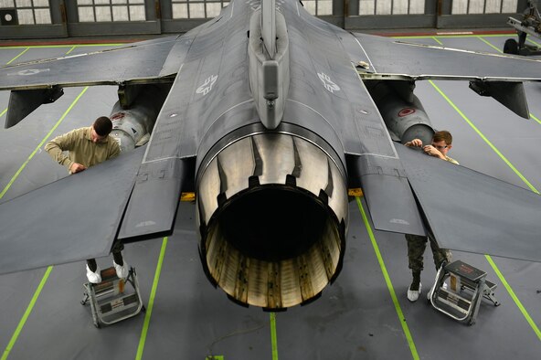 Airman 1st Class Zachary Bradley (left) and Airman Joseph Glenn, 20th Equipment Maintenance Squadron aircraft structural maintenance apprentices, remove leading edge tape prior to painting an F-16CM Fighting Falcon at Shaw Air Force Base, S.C., Dec. 14, 2016. Leading edge tape serves as a repellent against rain and prevents the F-16’s wing edges and tail flaps from rusting and corroding. (U.S. Air Force photo/Airman 1st Class Christopher Maldonado)