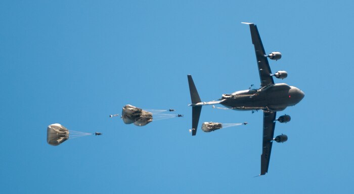 U.S. and foreign paratroopers jump from a C-17 during Operation Toy Drop XIX Dec., 10 at Luzon drop zone at Camp Mackall, N.C.  During OTD U.S. paratroopers have the chance to train with jumpmasters from other nations, learn about their training tactics, and expand their experience through working with partner nations. (U.S. Army photo by Spc. Tynisha L. Daniel)