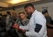 Former Heisman Trophy winner Herschel Walker signs autographs following his visit with Airmen in the 377th Weapons System Security Squadron during his visit to Kirtland Dec. 12-13. Walker spoke at multiple venues on base, detailing his struggles with mental illness and encouraging those with issues to seek help.  