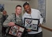 Former pro football player Herschel Walker poses with plaques he signed for Staff Sgt. Brandon Stamper of the 377th Weapons System Security Squadron during his visit to the base Dec. 12-13. Walker came to the base to tell Airmen about his suffering with a mental illness. He said there is no shame in asking for help.