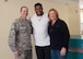 Former Heisman Trophy winner Herschel Walker takes a moment to pose with Col. Eric Froehlich, 377th Air Base Wing commander, and his wife Stephanie, during his visit to Kirtland Dec. 12-13.  Walker spoke at multiple venues on base, detailing his struggles with mental illness and encouraging those with issues to seek help.  