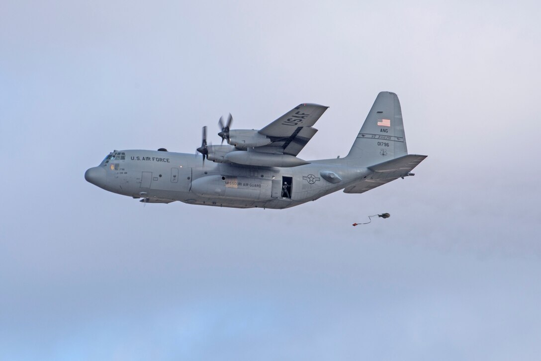 In a first for the 375th Air Mobility Wing and the next step in certifying a new Drop Zone area for use on Scott’s flight line, a C-130 performs a test air drop Dec. 13, 2016, Scott Air Force Base, Ill. The 375th Operational Support Squadron created the Drop Zone to increase the readiness of units in and around Scott and for use by flying or ground units with an interest and the requirement. This new capability opens up a multitude of functions that the airfield can provide, making Scott a desired destination for aviators and jumpers. The C-130 was from the 180th Airlift Squadron, Air National Guard, St. Joseph, Mo.
