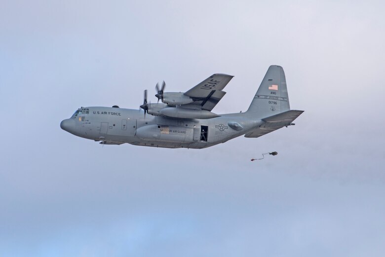 In a first for the 375th Air Mobility Wing and the next step in certifying a new Drop Zone area for use on Scott’s flight line, a C-130 performs a test air drop Dec. 13, 2016, Scott Air Force Base, Ill. The 375th Operational Support Squadron created the Drop Zone to increase the readiness of units in and around Scott and for use by flying or ground units with an interest and the requirement. This new capability opens up a multitude of functions that the airfield can provide, making Scott a desired destination for aviators and jumpers. The C-130 was from the 180th Airlift Squadron, Air National Guard, St. Joseph, Mo.