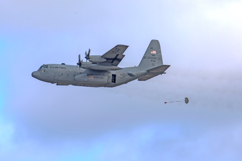 In a first for the 375th Air Mobility Wing and the next step in certifying a new Drop Zone area for use on Scott’s flight line, a C-130 performs a test air drop Dec. 13, 2016, Scott Air Force Base, Ill. The 375th Operational Support Squadron created the Drop Zone to increase the readiness of units in and around Scott and for use by flying or ground units with an interest and the requirement. This new capability opens up a multitude of functions that the airfield can provide, making Scott a desired destination for aviators and jumpers. The C-130 was from the 180th Airlift Squadron, Air National Guard, St. Joseph, Mo.