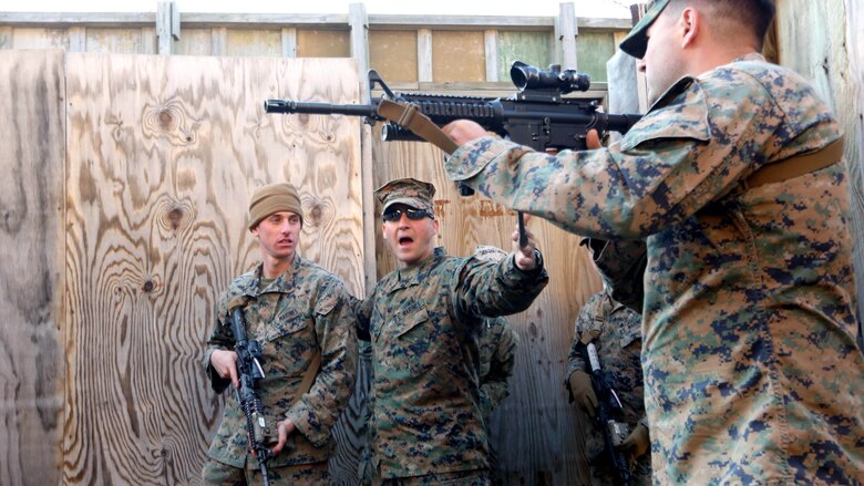 Staff Sgt. Travis A. Musto (center) walks his personnel safety officers through the Urban Assault Course during their deployment for training exercise at Fort Pickett, Va., Dec. 2, 2016. Marines conducted live-fire drills to become technically and tactically proficient with maneuvering in an urban environment. Musto is a platoon sergeant with Weapons Company, 3rd Battalion, 8th Marine Regiment. 