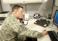 Staff Sgt. Mitchell Smith, Equal Opportunity specialist, takes a phone call during his shift at the 11th Wing Equal Opportunity Office at Joint Base Andrews, Md., December 13, 2016. Like all EO Airmen, Mitchell completed 11 weeks of technical school at the DoD Equal Opportunity Management Institute located at Patrick Air Force Base, Fla. (U.S. Air Force photo by Staff Sgt. Joe Yanik)
