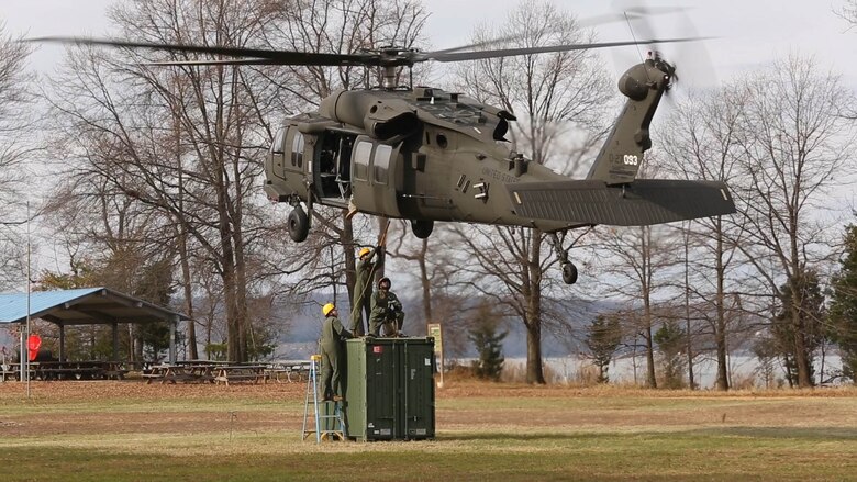 Embarkation specialist Marines with Chemical Biological Incident Response Force, CBIRF, attach a container of supplies to an UH-60 Blackhawk helicopter during a sling load operation as part of Initial Reaction Force B certification exercise, CERTEX, at Naval Support Facility Indian Head Annex Stump Neck, Md., Dec. 13, 2016. This CERTEX evaluated all sections composing the IRF including identification and detection, technical rescue, decontamination, search and rescue/casualty extraction, medical, explosive ordnance disposal, as well as command and control.  