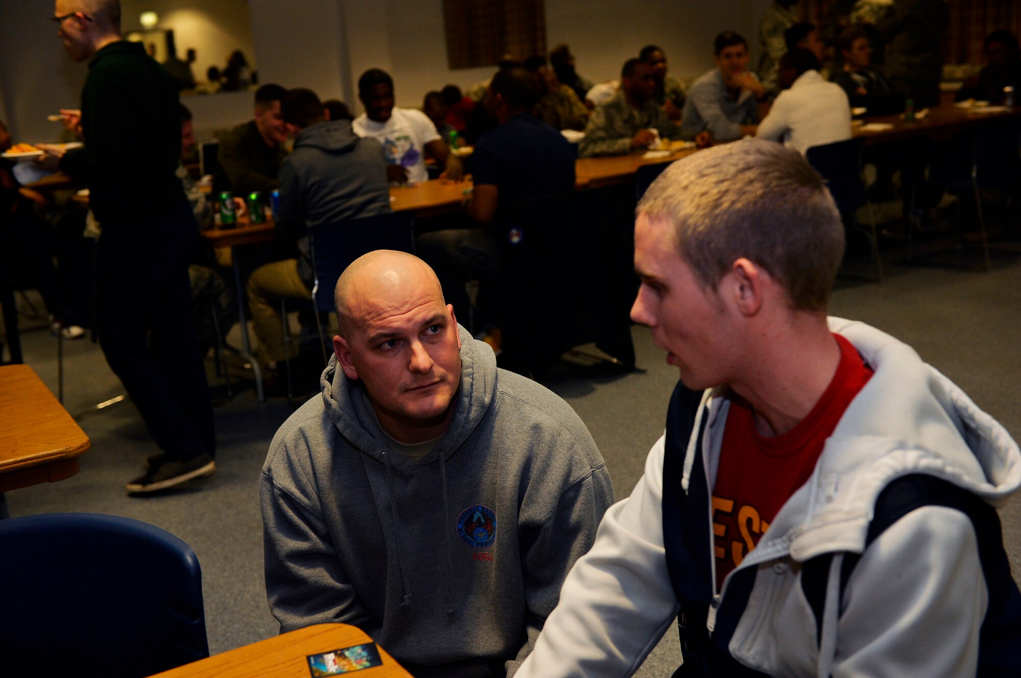 Master Sgt. Timothy Herrman, left, U.S. Air Forces Europe unit deployment cell superintendent, listens to an Airman during a Huddle meeting at Ramstein Air Base, Dec. 13, 2016. The Huddle is a club which aims to provide mentorship opportunities for junior Airmen. (U.S. Air Force photo by Airman 1st Class Joshua Magbanua)