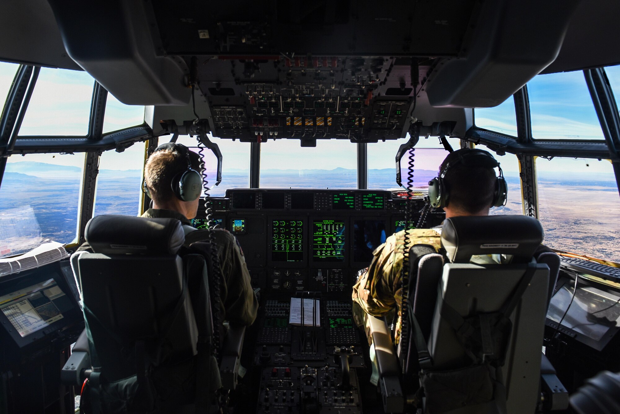Maj. Brian Pesta, left, and Maj. Justin Eulberg, pilots with the 1st Special Operations Group, Detachment 2, fly the AC-130J Ghostrider over White Sands Missile Range, N.M., Dec. 13, 2016. The 1st SOG, Det 2, went to Cannon AFB, N.M. to continue operational testing of Laser Small Diameter Bomb drops. (U.S. Air Force photo by Senior Airman Jeff Parkinson)
