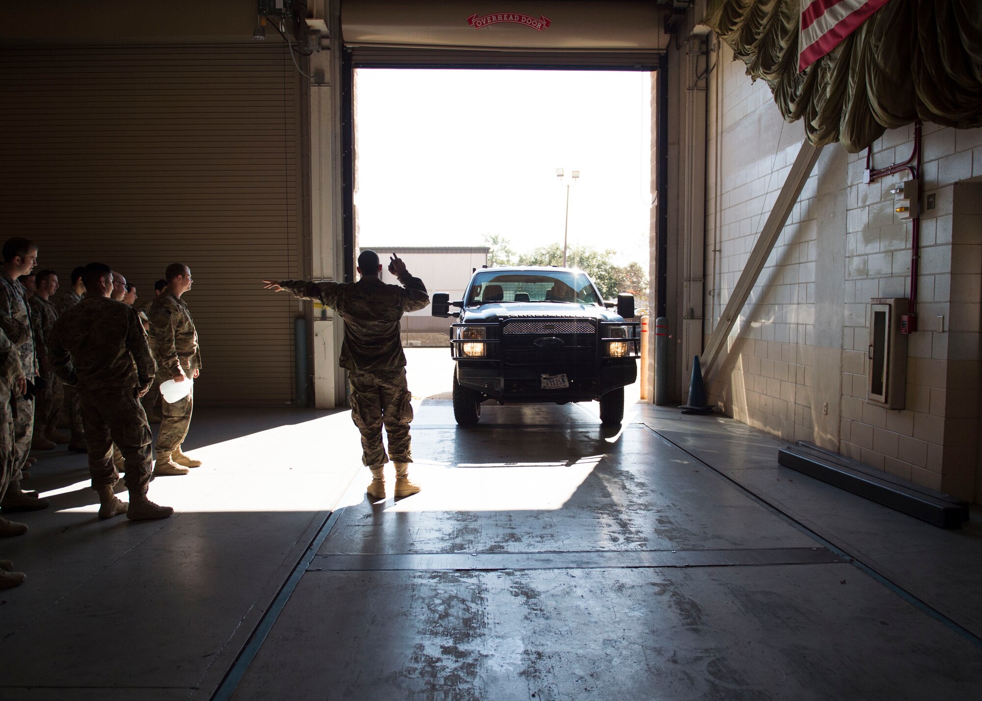 Staff Sgt. Brendon Walsh, an air terminal and aerial delivery craftsman with the 1st Special Operations Logistic Readiness Squadron, marshals a vehicle onto a scale during pallet build-up training at Hurlburt Field, Fla., Dec. 12, 2016. AFE Air Commandos were trained to properly weigh and document vehicles for cargo loading. The training ensures Air Commandos are ready to execute global special operations. (U.S. Air Force photo by Senior Airman Krystal M. Garrett)