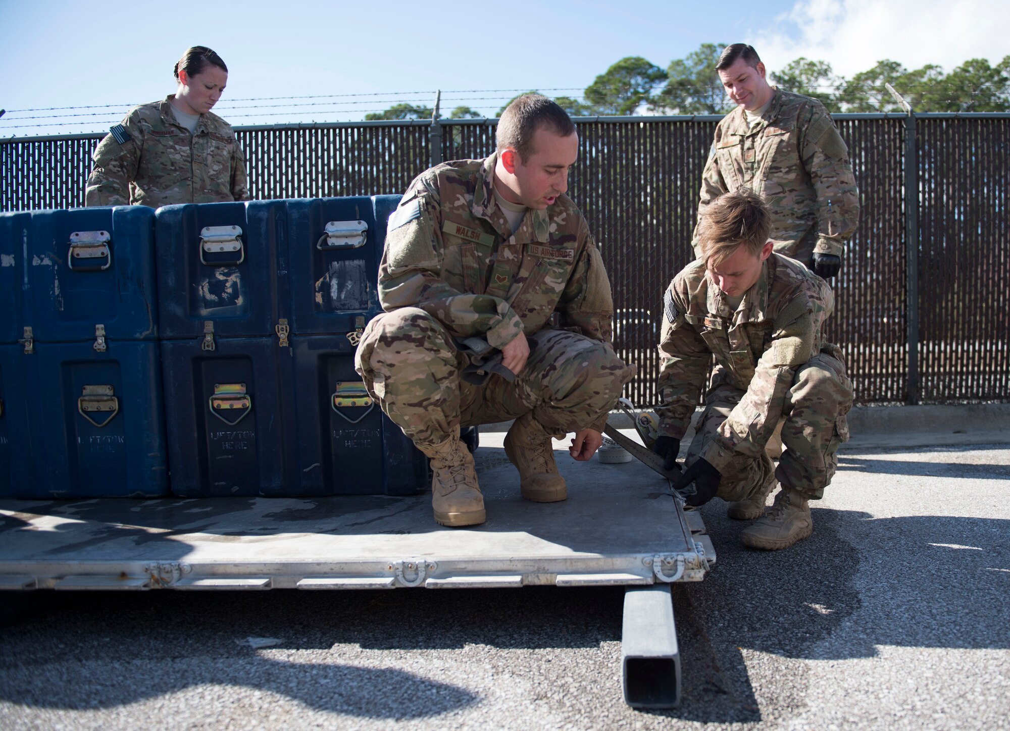 Staff Sgt. Brendon Walsh, an air terminal and aerial delivery craftsman with the 1st Special Operations Logistic Readiness Squadron, shows Staff Sgt. Jacob Wade, an aircrew flight equipment craftsman with the 4th Special Operations Squadron, how to strap down cargo during pallet build-up training at Hurlburt Field, Fla., Dec. 12, 2016. Pallet build-up training is an annual training that enables AFE Air Commandos to properly document and load cargo onto aircraft, ensuring readiness to execute global special operations. (U.S. Air Force photo by Senior Airman Krystal M. Garrett)