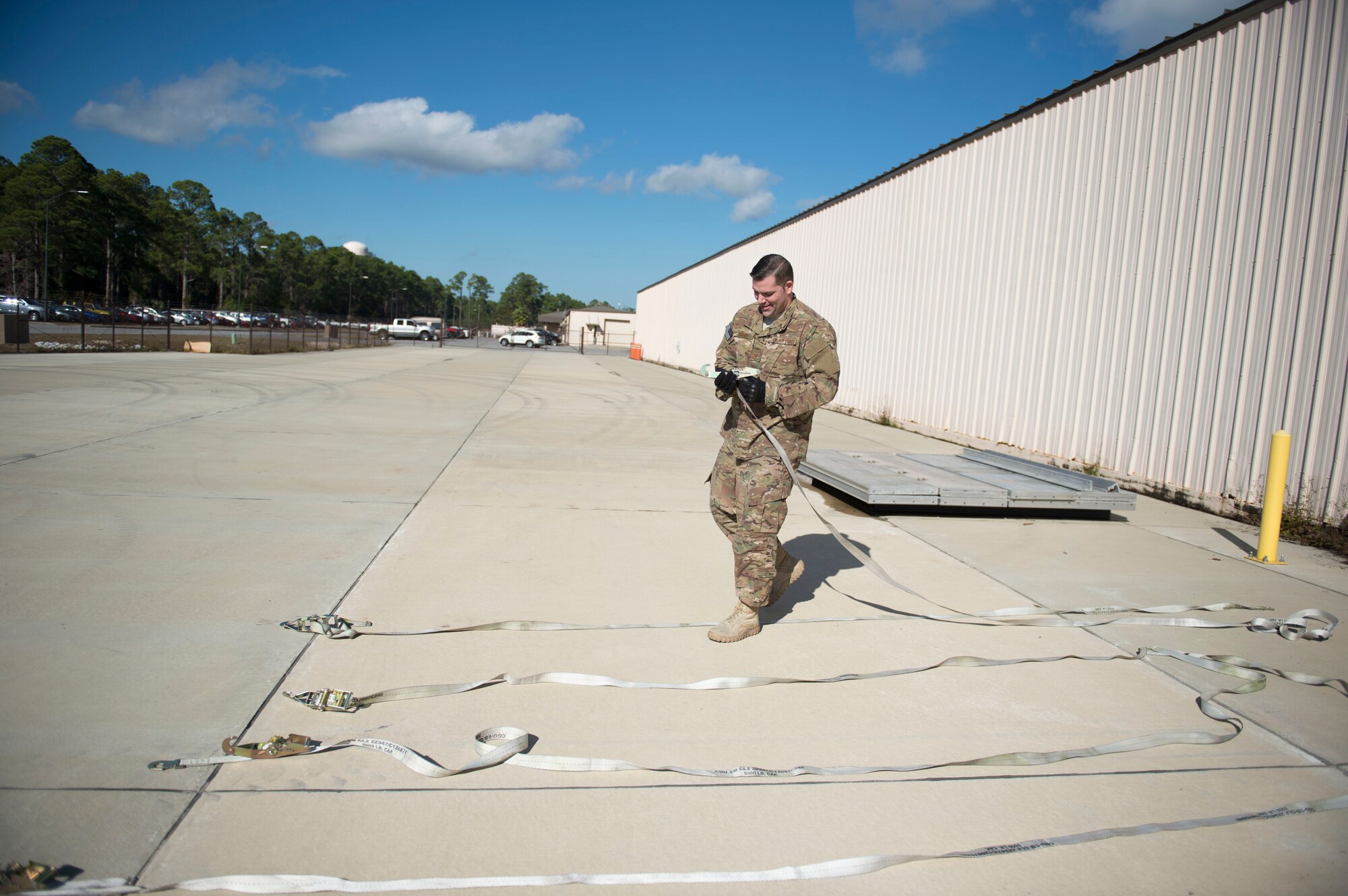 Tech. Sgt. David Sigers, an aircrew flight equipment craftsman with the 15th Special Operations Squadron, separates straps during pallet build-up training at Hurlburt Field, Fla., Dec. 12, 2016. AFE Air Commandos were trained to properly weigh and document vehicles for cargo loading. The training ensures Air Commandos are ready to execute global special operations. (U.S. Air Force photo by Senior Airman Krystal M. Garrett)