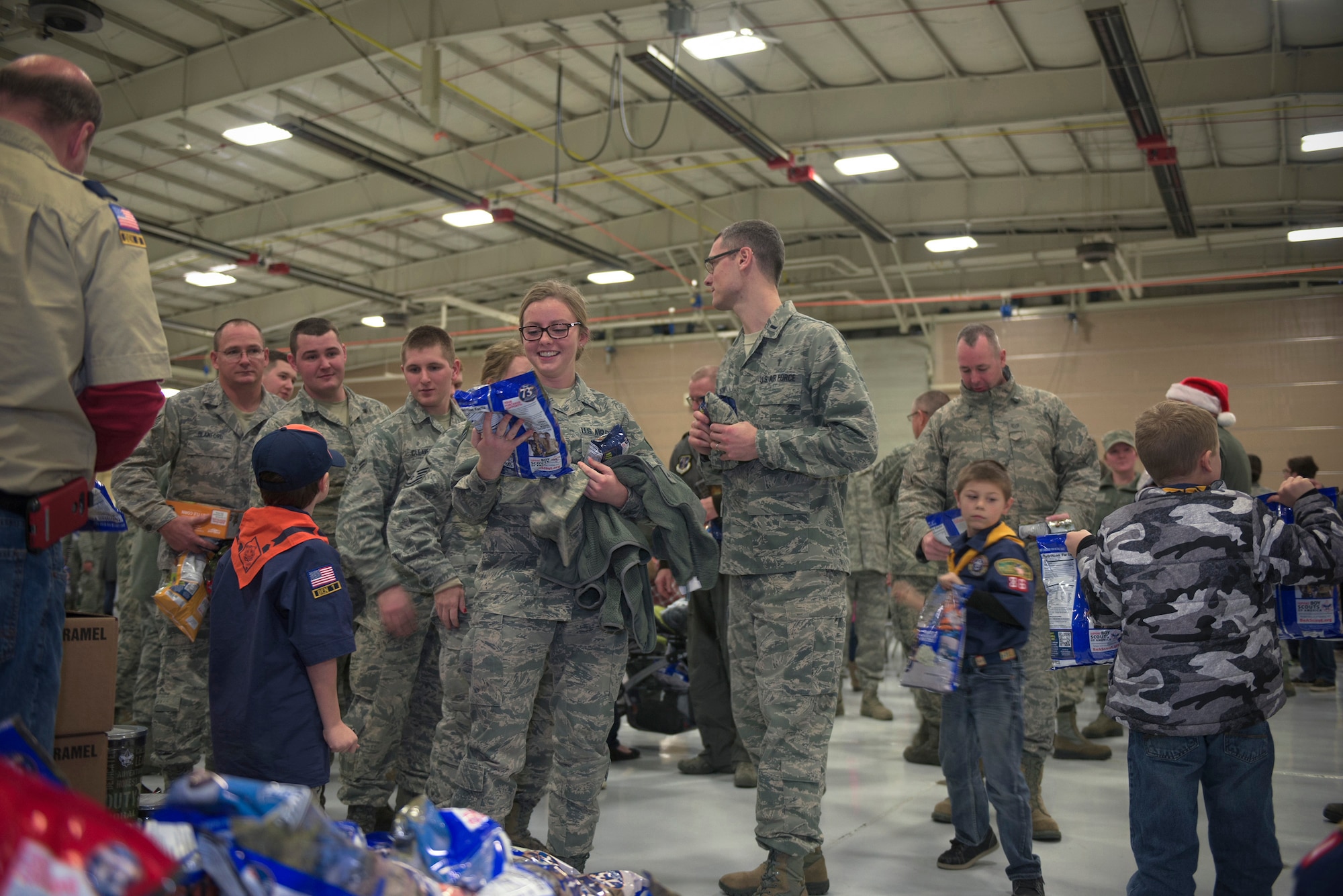 Boy Scouts from W.D. Boyce Council distribute donated popcorn to Airmen with 182nd Airlift Wing, Illinois Air National Guard, in Peoria, Ill., Dec. 3, 2016. The scouts’ donation coincided with wing’s annual holiday party. (U.S. Air National Guard photo by Tech. Sgt. Lealan Buehrer)