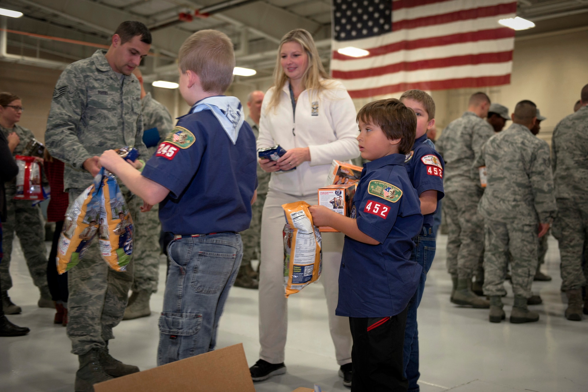 Boy Scouts from W.D. Boyce Council distribute donated popcorn to Airmen with 182nd Airlift Wing, Illinois Air National Guard, in Peoria, Ill., Dec. 3, 2016. The scouts’ donation coincided with wing’s annual holiday party. (U.S. Air National Guard photo by Tech. Sgt. Lealan Buehrer)