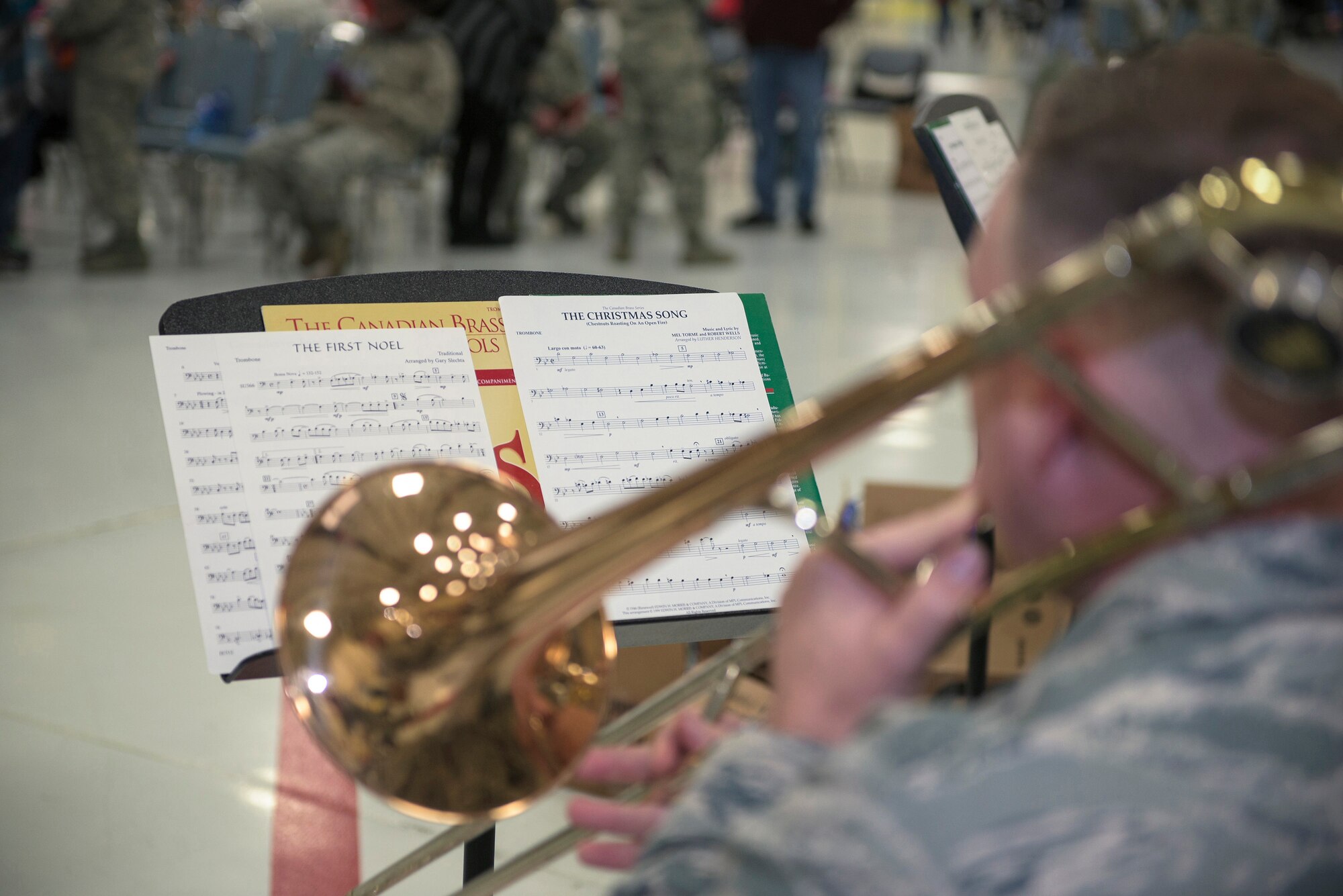 U.S. Air Force Staff Sgt. John Cavanaugh, an instrumentalist with the 566th Air Force Band, Illinois Air National Guard, plays holiday music on the trombone at the 182nd Airlift Wing’s annual holiday party Dec. 3 in Peoria, Ill. The wing held the event to provide ANG families an opportunity to celebrate with their fellow unit members. (U.S. Air National Guard photo by Tech. Sgt. Lealan Buehrer)