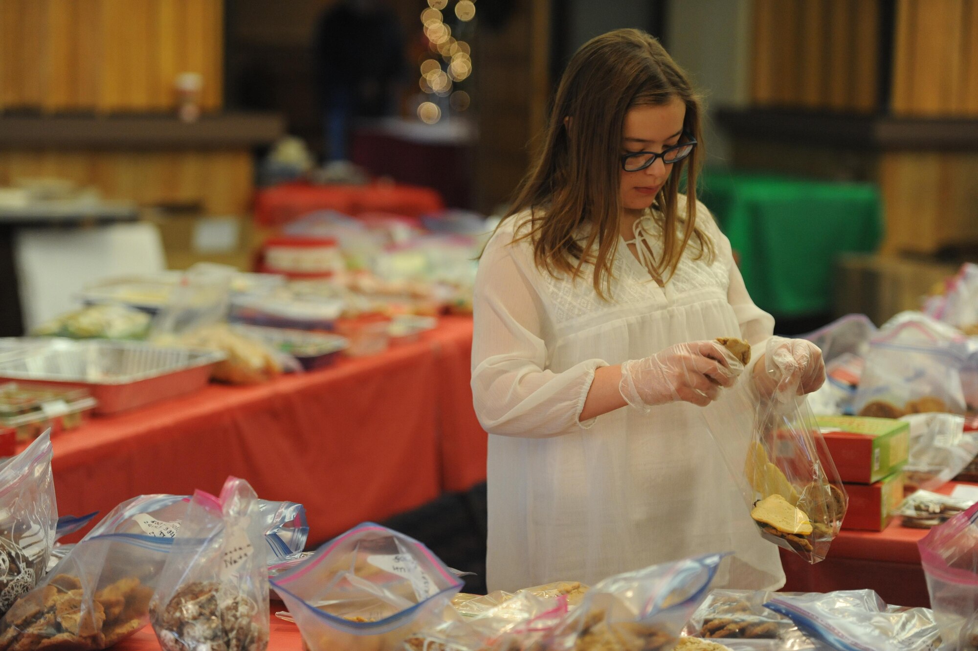 Lara Arnold, 12, puts together cookie packages to be delivered to Airmen living on base as part of the Kirtland Spouses’ Club's annual cookie drive. The KSC rolled past its goal of collecting about 10,000 cookie, collecting more than 12,000 cookies from the base community.