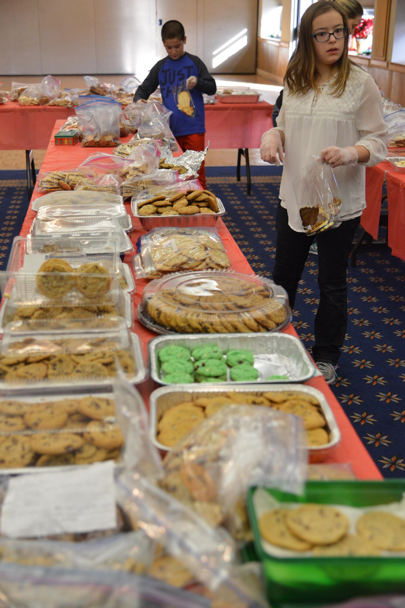 Volunteers help put together cookie packages to be delivered to Airmen living on base as part of the Kirtland Spouses’ Club's annual cookie drive. The KSC rolled past its goal of collecting about 10,000 cookie, collecting more than 12,000 cookies from the base community.