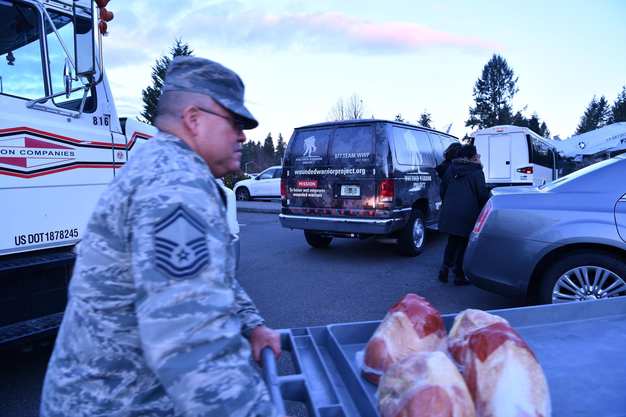 Senior Master Sgt. Carlos Gonzales, 225th Support Squadron, transports donated holiday hams during Operation Ham Grenade, sponsored by the Association of the United States Army, Air Force Association, and Pierce Military and Business Alliance, into the Western Air Defense Sector building Dec. 16.  (U.S. Air National Guard photo by Kimberly D. Burke)