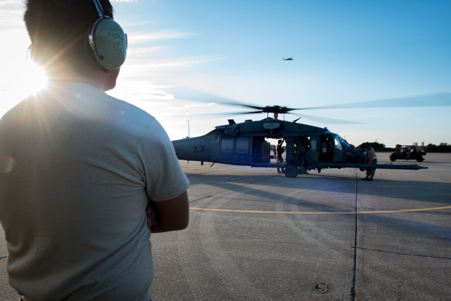 Senior Airman Aaron Mier, 41st Helicopter Maintenance Unit crew chief, watches as an HH-60G Pave Hawk prepares to launch, Dec. 12, 2016, at Patrick Air Force Base, Fla. Airmen performed hot refueling and crew changes, meaning the aircraft never shut off during the procedures. (U.S. Air Force photo by Airman 1st Class Daniel Snider)