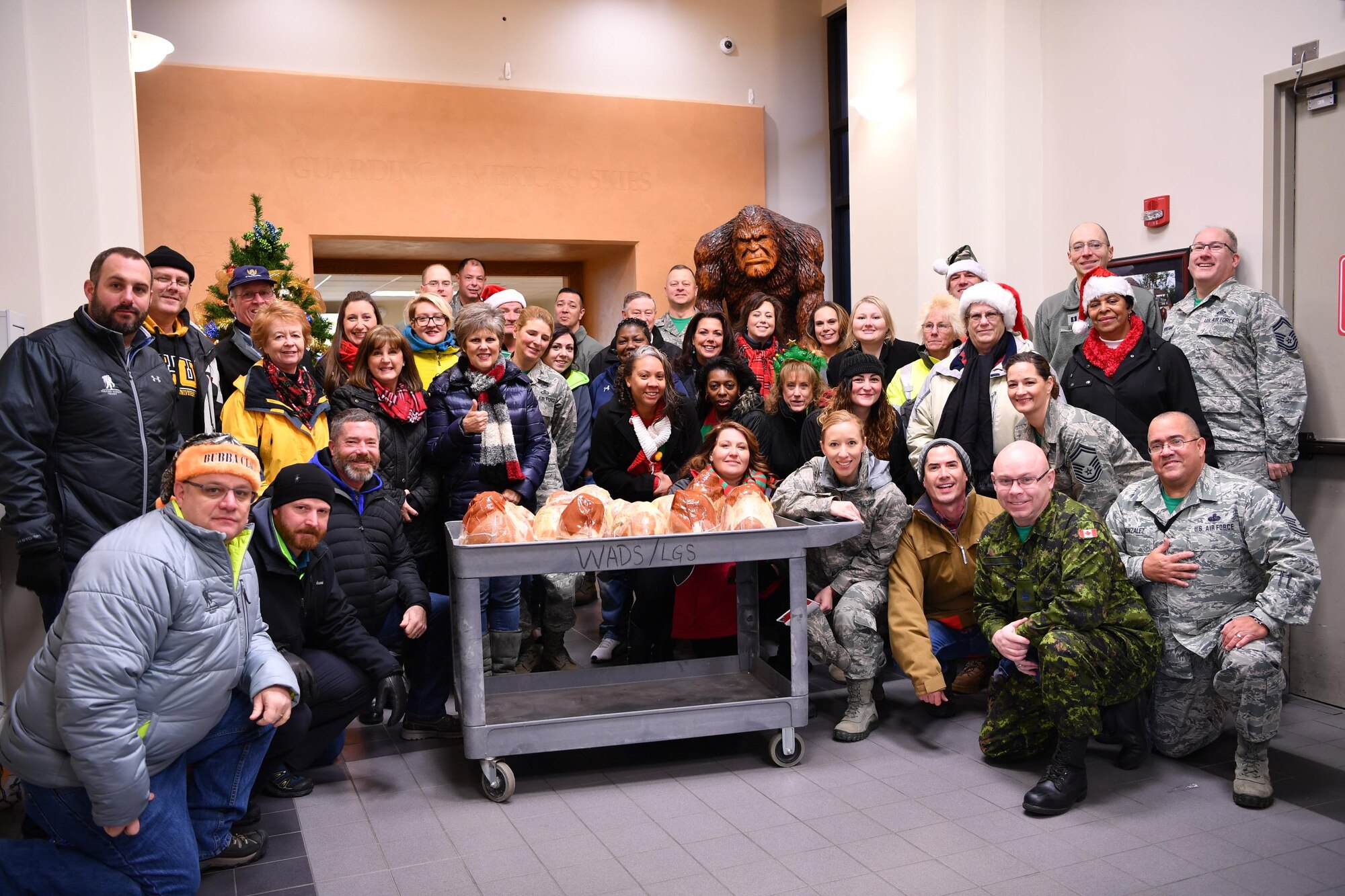 Volunteers of Operation Ham Grenade gather for a group picture inside the Western Air Defense Sector Dec. 16.   Members of the Association of the United States Army, the Air Force Association, local business leaders and the Pierce Military and Business Alliance, delivered 20 complimentary holiday hams to WADS junior servicemembers as a way to show their appreciation and support.  (U.S. Air National Guard photo by Kimberly D. Burke) 
	
