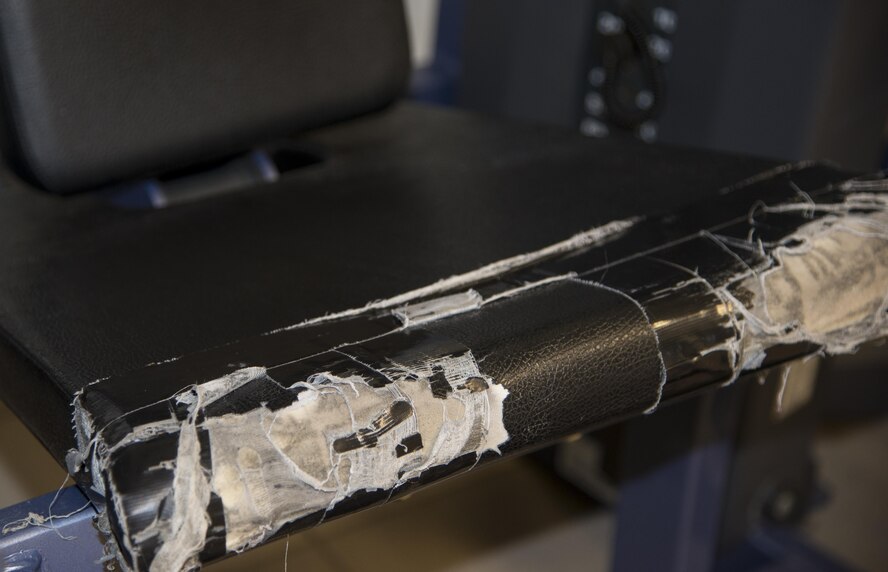 A five-year-old leg extension machine sits outside the free-weight section of the fitness center and is currently taped off awaiting removal, Dec. 15, 2016, at Moody Air Force Base, Ga. Equipment in the Freedom 1 Fitness Center is replaced every five years, as recommended by the base fitness and sports manager.  (U.S. Air Force photo by 2d Lt. Kaitlin Toner)