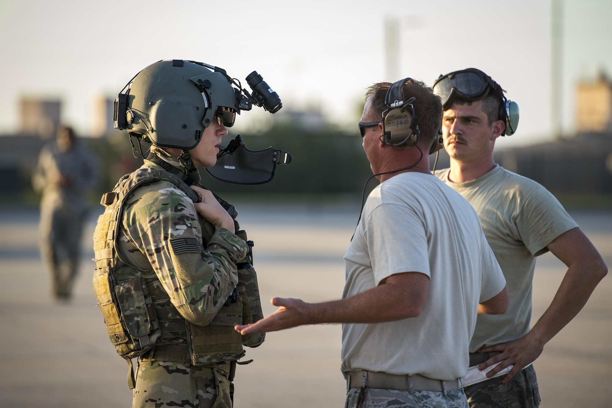 An aircrew member from the 41st Rescue Squadron discusses the maintenance status of an HH-60G Pave Hawk with airmen from the 41st Helicopter Maintenance Unit after a mission, Dec. 12, 2016, at Patrick Air Force Base, Fla. The 41st HMU worked alongside the 41st Rescue Squadron for ten days as they conducted pre-deployment “spin-up” training. The maintainers were responsible for ensuring three aircraft were combat-ready at a moment’s notice and worked around the clock to meet this requirement for both day and night missions. (U.S. Air Force photo by Staff Sgt. Ryan Callaghan)