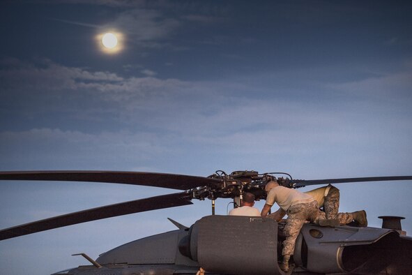 Maintainers from the 41st Helicopter Maintenance Unit inspect the engines of an HH-60G Pave Hawk after a reported bird strike, Dec. 12, 2016, at Patrick Air Force Base, Fla. The 41st HMU worked alongside the 41st Rescue Squadron for ten days as they conducted pre-deployment “spin-up” training. The maintainers were responsible for ensuring three aircraft were combat-ready at a moment’s notice and worked around the clock to meet this requirement for both day and night missions. (U.S. Air Force photo by Staff Sgt. Ryan Callaghan)
