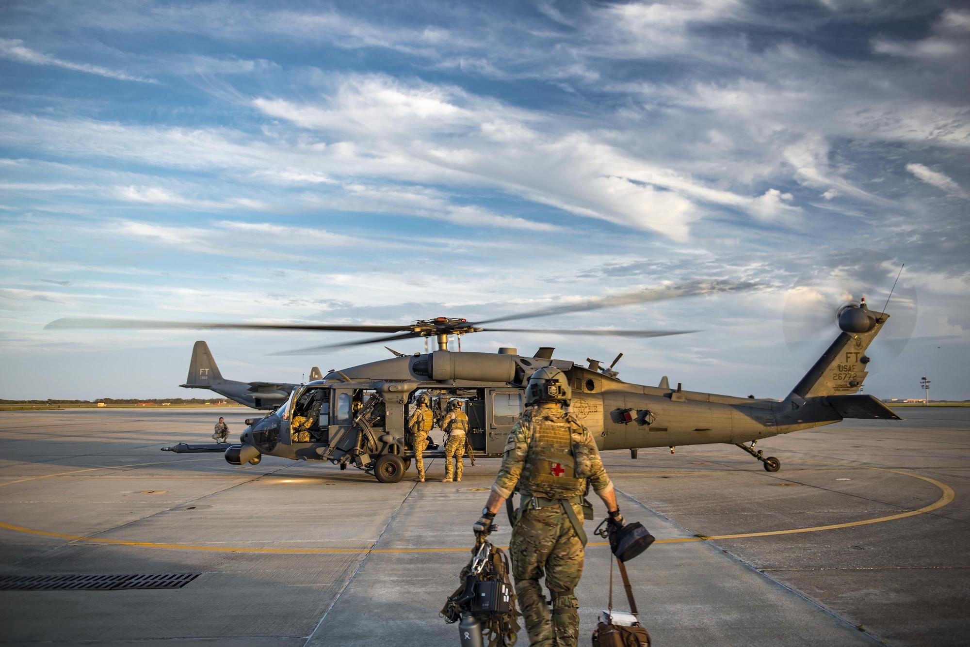 A special missions aviator from the 41st Rescue Squadron walks towards an HH-60G Pave Hawk for an engine-running crew swap during a pre-deployment ‘spin-up’ exercise, Dec. 12, 2016, at Patrick Air Force Base, Fla. During the spin-up, the 41st RQS, alongside mission partners from the 38th and 71st Rescue Squadrons, conducted high-tempo rescue operations designed to mimic the missions they will fly downrange. They based their operations out of Patrick AFB and flew missions to Avon Park Air Force Range, Fla. (U.S. Air Force photo by Staff Sgt. Ryan Callaghan)