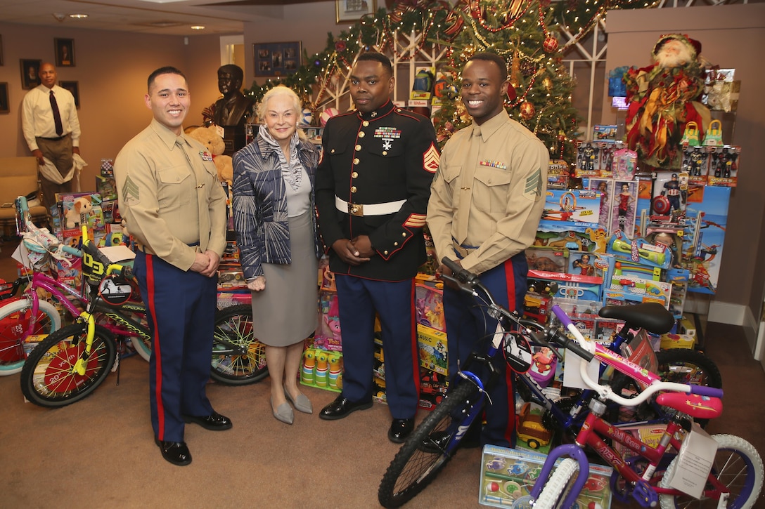 From left to right, Sgt. Christopher Vidaurre, protocol clerk with Headquarters Battalion, Marine Forces Reserve, Phyllis M. Taylor, Staff Sgt. Sylvester T. Dollard, security administrative staff noncommissioned officer in charge at MARFORRES, and Sgt. Joseph a White, protocol clerk with HQBN, MARFORRES, stand in front of toys collected and donated by Patrick F. Taylor Foundation’s employees at the Patrick F. Taylor Foundation building in New Orleans, Dec. 14, 2016. Every year the Patrick F. Taylor Foundation receives individual donations from its employees in order to support the Toys For Tots annual toy drive. The program collects new, unwrapped toys during the holiday season so that less fortunate children may have a new toy to open during the holidays. (U.S. Marine Corps photo by Sgt. Ian Ferro)