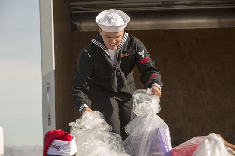 Petty Officer 2nd Class Johnathan Lough-Wekell, corpsman, 4th Tank Battalion, loads toys into a truck during the 2nd annual Toys for Tots Fly-in, Dec. 10, 2016. (Official Marine Corps photo by Cpl. Levi Schultz/Released)