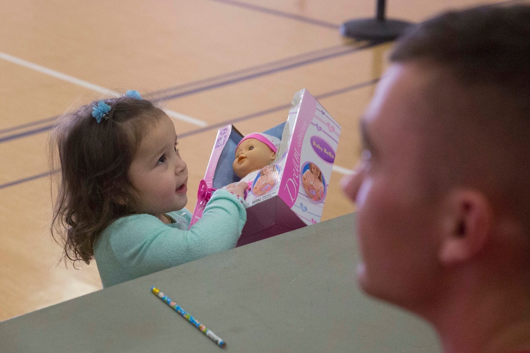 Melissa Moreira, 2, daughter of  Sgt. Gabriel Moreira, high mobility artillery rocket system operator, 1st Battalion, 7th Marine Regiment, selects a toy during Marine Corps Community Service’s annual Combat Center Toy Giveaway in the West Gym aboard Marine Corps Air Ground Combat Center, Twentynine Palms, Calif., Dec. 10, 2016. (Official Marine Corps photo by Cpl. Medina Ayala-Lo/Released)
