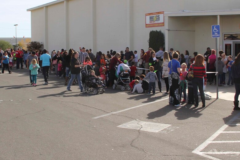 Marines and sailors wait outside of the West Gym prior to Marine Corps Community Service’s annual Combat Center Toy Giveaway aboard Marine Corps Air Ground Combat Center, Twentynine Palms, Calif., Dec. 10, 2016. (Official Marine Corps photo by Jill Weber/Released)