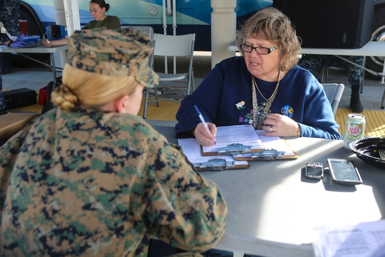 Doreen Rekoski, blood donor recruiter for Naval Medical Center, San Diego, talks with a Marine about donating blood aboard Marine Corps Air Station Miramar, Calif., Dec. 14. The Navy Medical Center of San Diego opens opportunities to service members on surrounding military bases in San Diego, to donate blood to the Armed Services Blood Program (ASBP).  (U.S. Marine Corps photo by Cpl. Harley Robinson/Released)