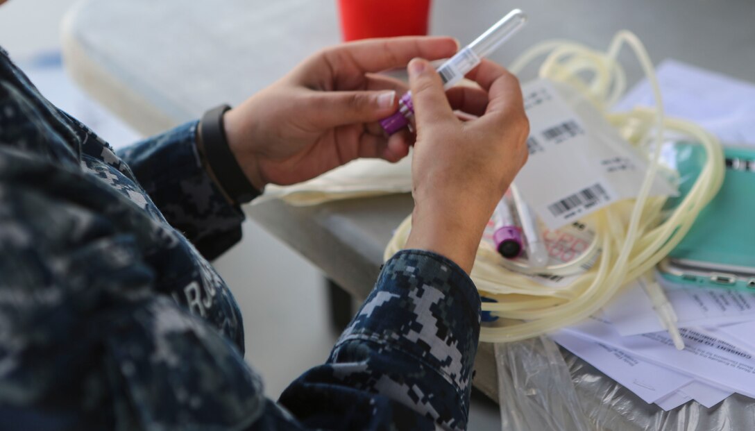 A staff member of the Naval Medical Center of San Diego, prepares for the blood drive aboard Marine Corps Air Station, Miramar, Calif., Dec. 14. The Navy Medical Center of San Diego opens opportunities to service members on surrounding military bases in San Diego, to donate blood to the Armed Services Blood Program (ASBP). (U.S. Marine Corps photo by Cpl. Harley Robinson/Released)