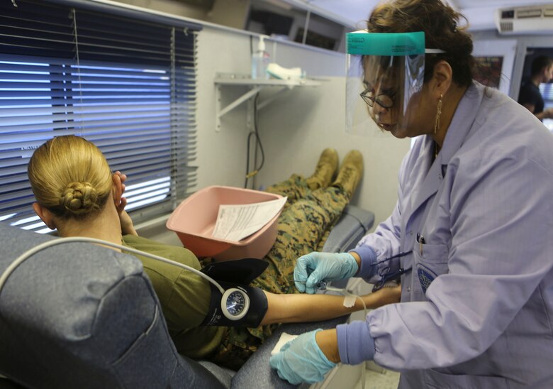 A Marine donates blood to the Armed Services Blood Program aboard Marine Corps Air Station Miramar, Calif., Dec. 14. The Navy Medical Center of San Diego opens opportunities to service members on surrounding military bases in San Diego, to donate blood to the ASBP. (U.S. Marine Corps photo by Cpl. Harley Robinson/Released)