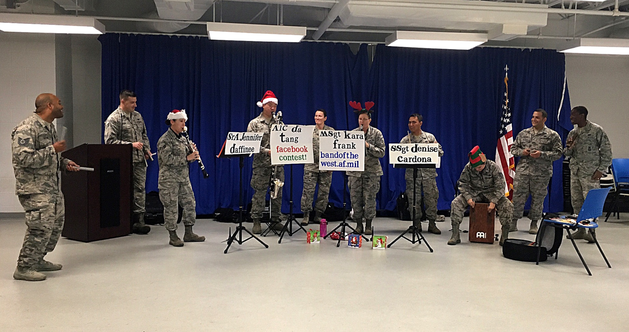 Members assigned to the 6th Security Forces Squadron play percussion instruments along with the Band of the West clarinet quartet, the Mission Winds, during their visit at MacDill Air Force, Fla., Dec. 14, 2016. The Mission Winds brought several percussion instruments to get their audience to participate in the holiday musical selections. (U.S. Air Force photo by Staff Sgt. Brittany Liddon)