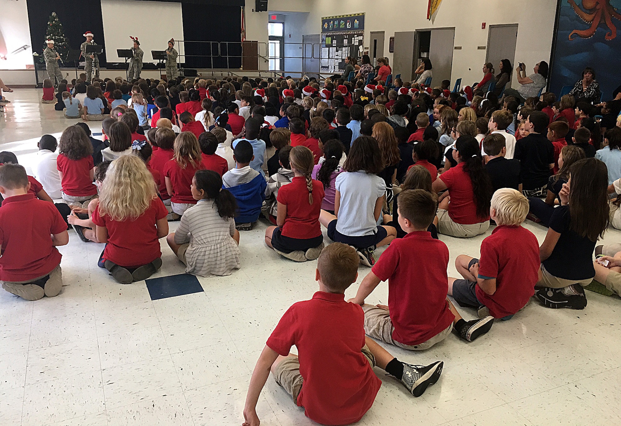 The Band of the West clarinet quartet, the Mission Winds, plays holiday music at Tinker K-8 School during their visit at MacDill Air Force Base, Fla., Dec. 15, 2016. During their visit to Tinker K-8, the Mission Winds played a holiday musical selection for the kindergarten through third grade classes. (U.S. Air Force photo by Staff Sgt. Brittany Liddon)