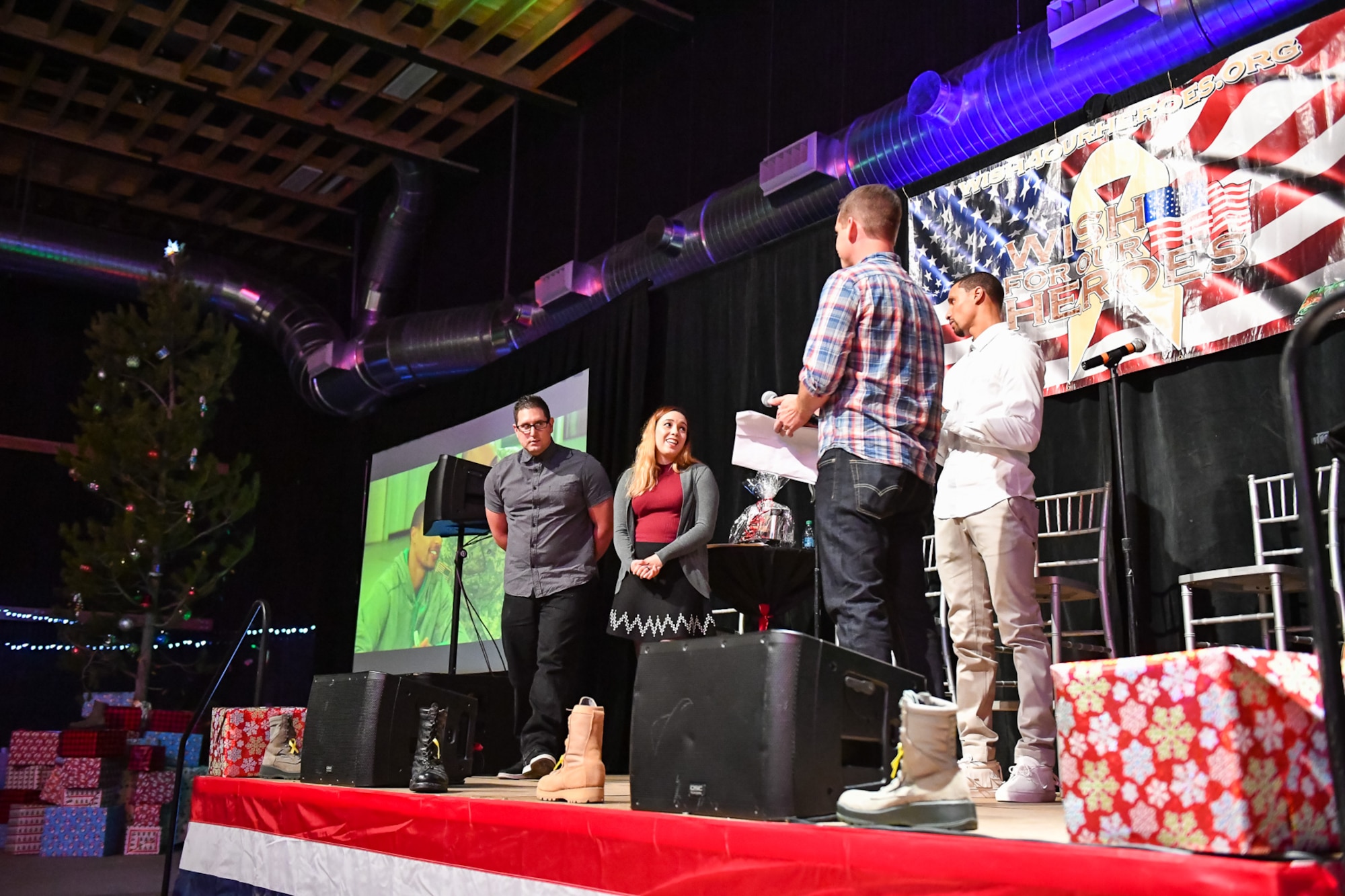 Staff Sgt. Daniel Cuevas, 309th Missile Maintenance Group, and his wife Patricia are granted their holiday wish by George Hill and Jeff Wells during the G3 Holiday Bash, Park City, Utah, Dec. 15, 2016. Four Hill Air Force Base families were granted wishes during the event. (U.S. Air Force photo/R. Nial Bradshaw)