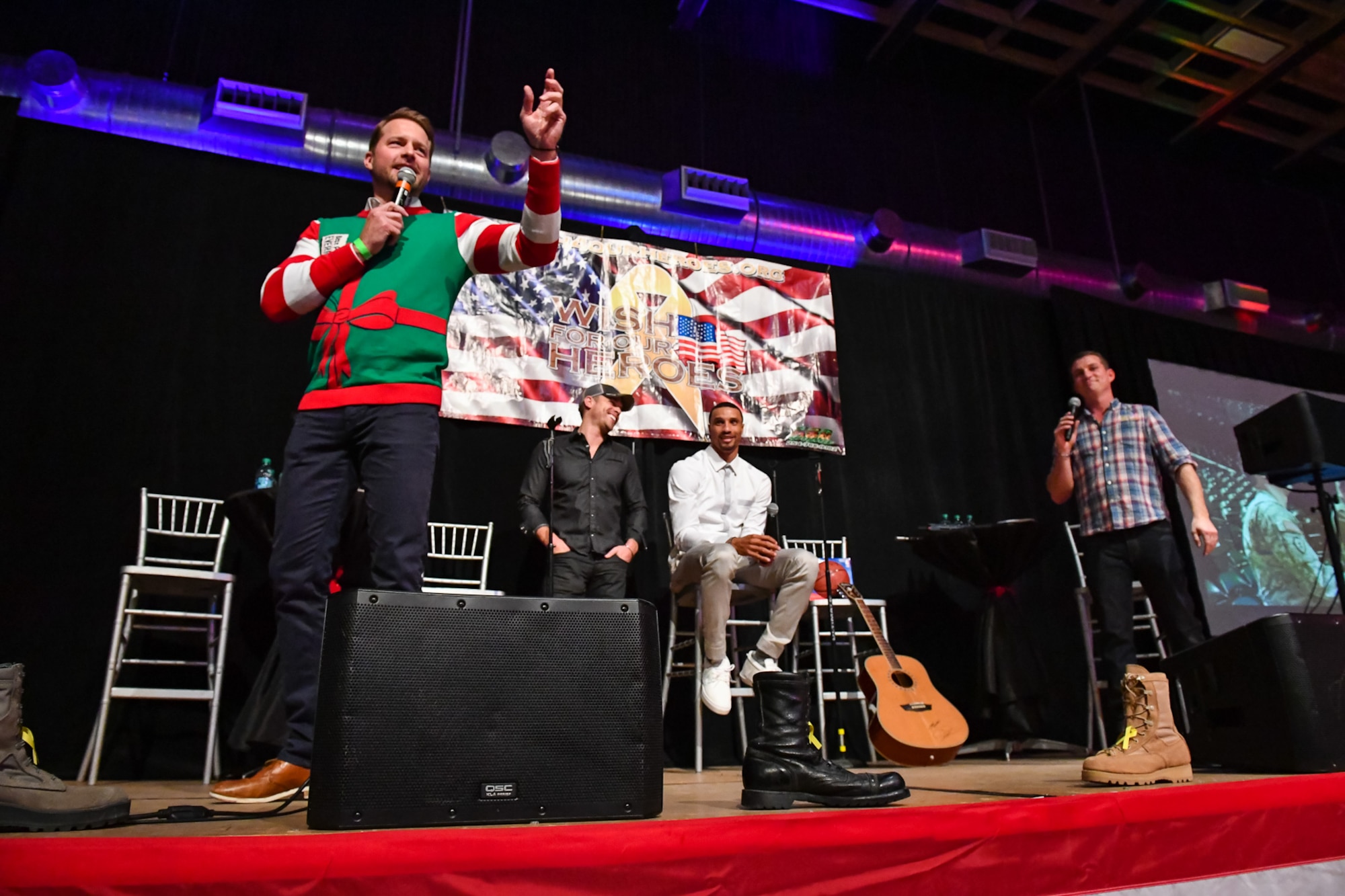 Actor Drew Waters takes bids during the G3 Holiday Bash, Park City, Utah, Dec. 15, 2016. All funds raised during the event will be used to assist Utah military families. Singer Dustin Lynch performed a special holiday concert following the auction. (U.S. Air Force photo/R. Nial Bradshaw)