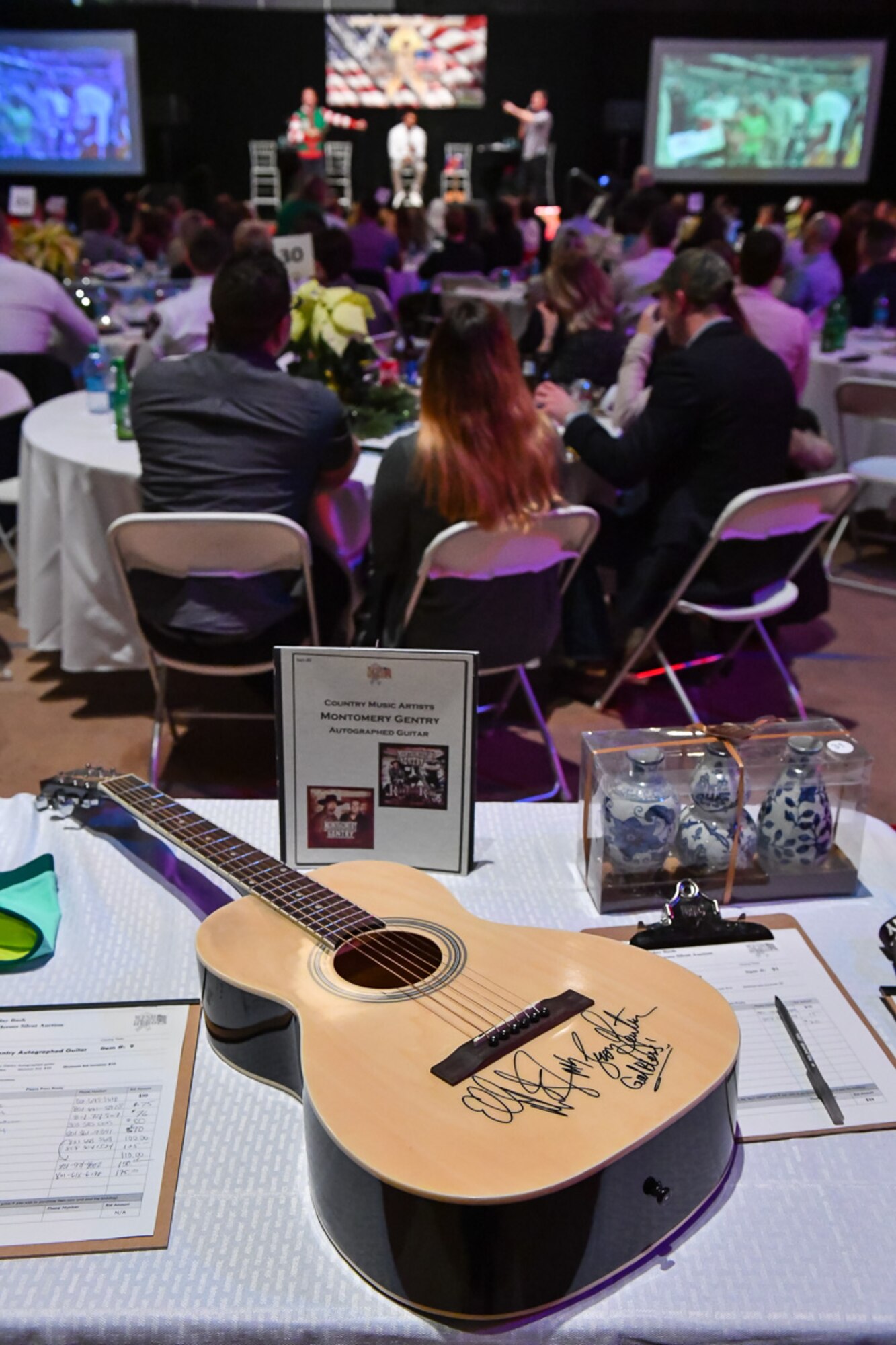 A guitar signed by Montgomery Gentry sits atop a table as a silent auction item during the G3 Holiday Bash, Park City, Utah, Dec. 15. 2016. The event featured live and silent auctions to raise money to assist local military families during the holiday season. (U.S. Air Force photo/R. Nial Bradshaw) 